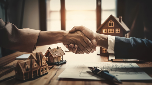 Two people shaking hands in agreement, symbolizing a friendly greeting or a deal being made.