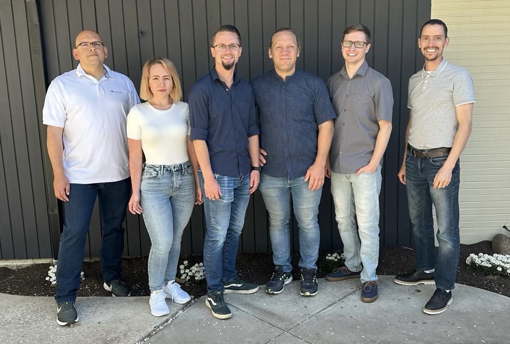 A group of professionals posing for a company photo.